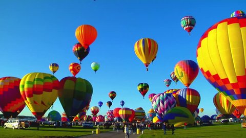Pan across beautiful balloons launching at the Albuquerque balloon festival Stockvideo