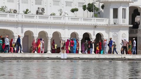 AMRITSAR, INDIA - SEPTEMBER 28, 2014: Unidentified Sikhs and indian people visiting the Golden Temple in Amritsar, Punjab, India. Sikh pilgrims travel from all over India to pray at this holy site.