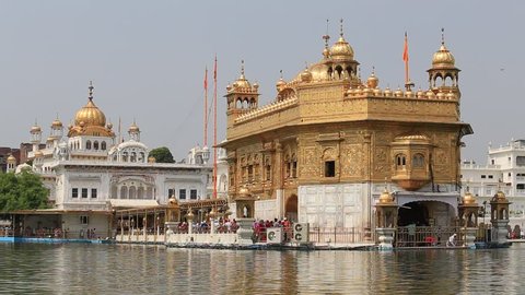AMRITSAR, INDIA - SEPTEMBER 28, 2014: Unidentified Sikhs and indian people visiting the Golden Temple in Amritsar, Punjab, India. Sikh pilgrims travel from all over India to pray at this holy site.
