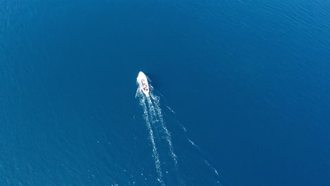 Aerial view of small boat on calm blue sea