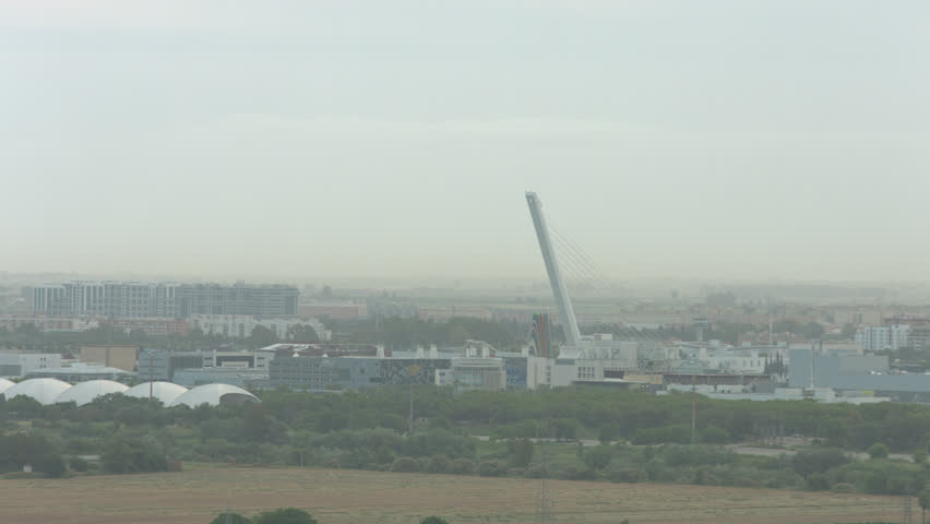 SEVILLE, SPAIN - January 13, 2015: Time-lapse of Alamillo bridge with overview of Seville. This bridge was designed by Santiago Calatrava. Ungraded ProRes 4444 Blackmagic 4K Camera.
