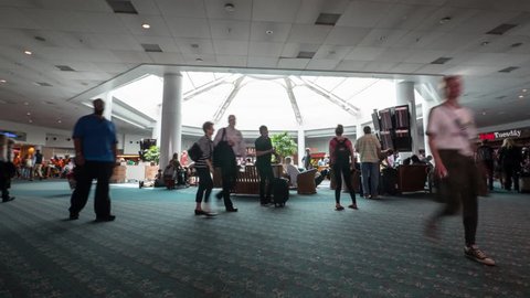 ORLANDO, USA - MARCH 27, 2016: (Time lapse) People walking inside Orlando International Airport Hall.