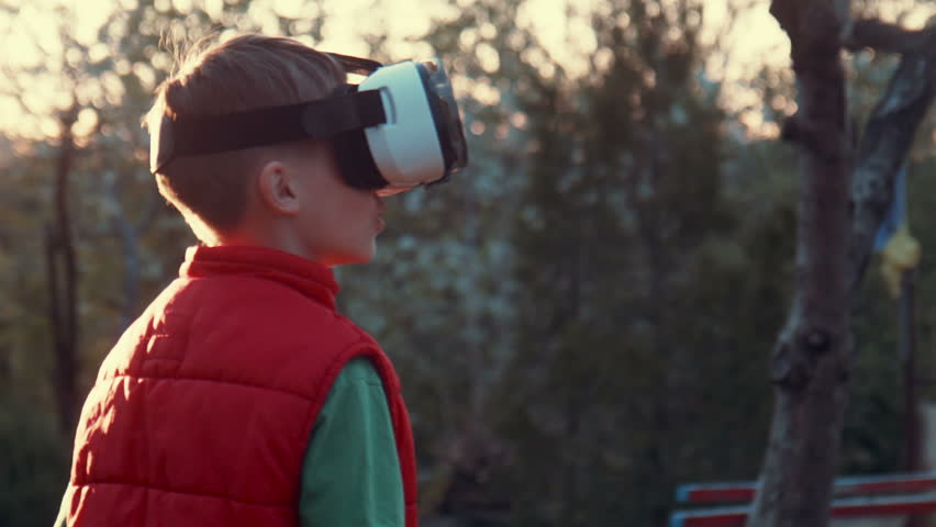 Little boy use virtual reality headset helmet, he very impressed Royalty-Free Stock Footage #16047967