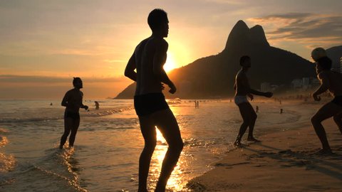 Rio de Janeiro, Brazil - December 19, 2015: Locals playing ball game at sunset at Ipanema beach in Rio de Janeiro, Brazil. 