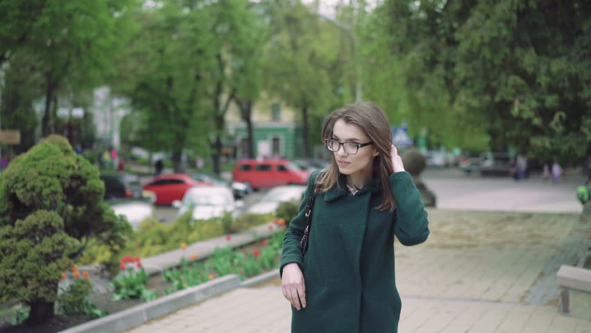 Beautiful girl posing at the camera, touching hair, smiling outdoor 4k