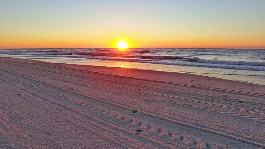 Aerial flying out over ocean at dawn at Myrtle Beach South Carolina. Flying low over ocean at sunrise on the east coast. 