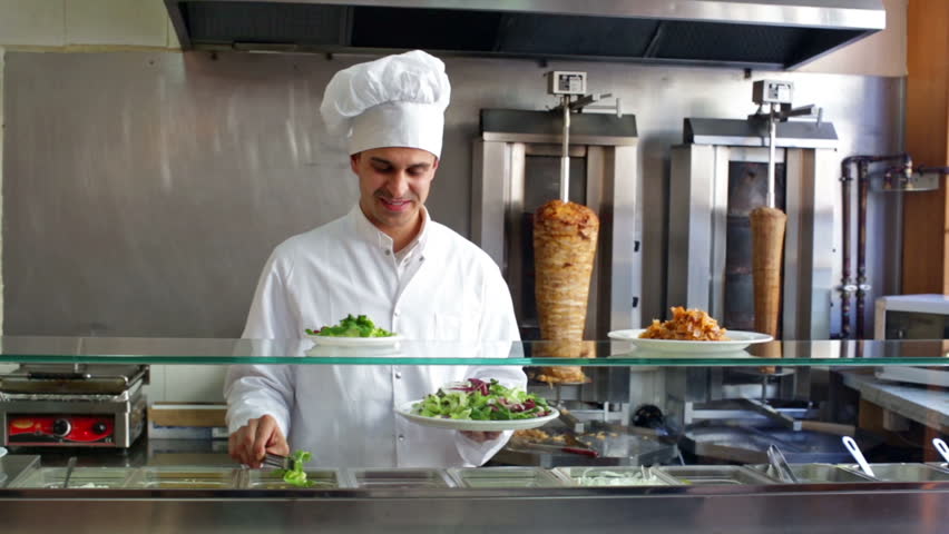 Indian cook offering tasty kebab at counter and smiling Royalty-Free Stock Footage #16065925