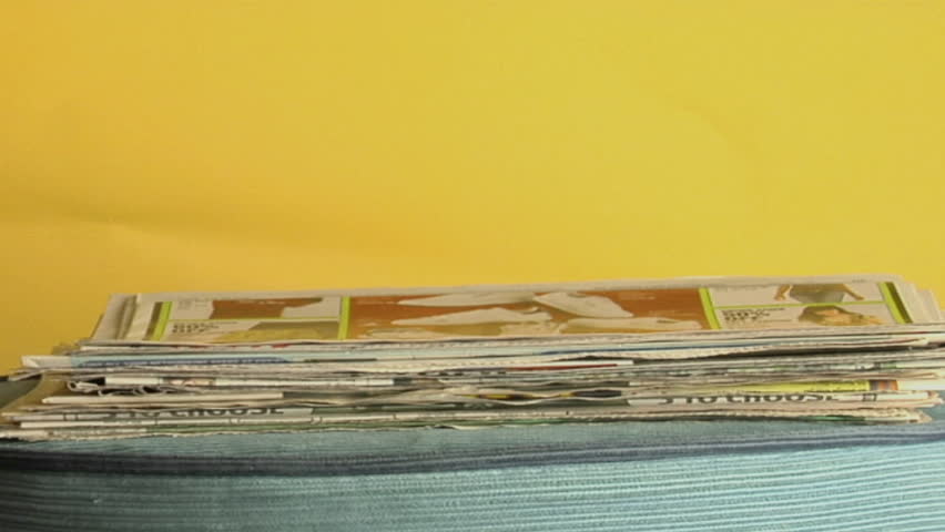 Newspapers stack up on a table | Shutterstock HD Video #1607014