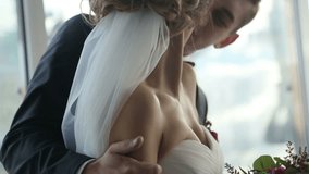 Happy young groom gently touches and kisses beautiful brunette bride close up. Very tender moment. Slow motion video