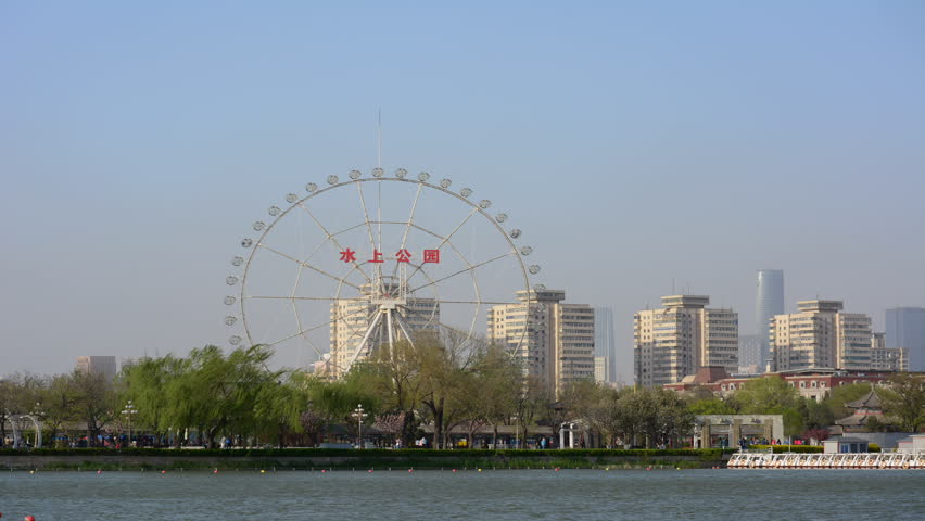 Tianjin,China - April 10,2016 : Time lapse view of Water park(shuishang park)with people walking in park,this park is the one of popular tourist attraction in Tianjin city.