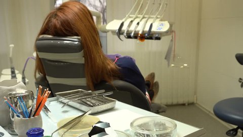 Young Woman in the Dentist's Chair Waiting For Waves in Dentistry