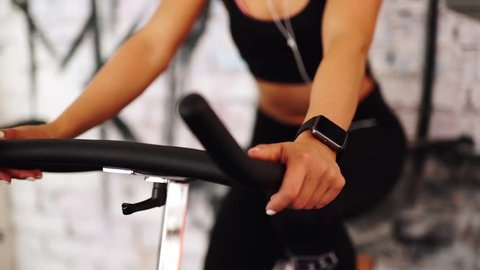Smart watch showing a heart rate of exercising woman in gym