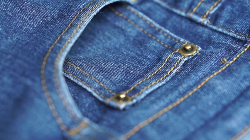 hand put card inside denim jeans pocket