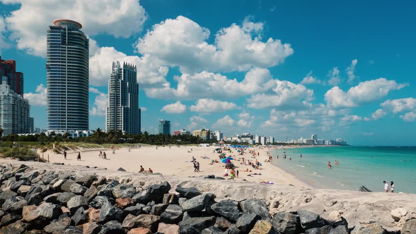 TIME LAPSE: South Beach full of people in a sunny day. South Beach (also known as SoBe), is one of the more popular areas of Miami Beach.