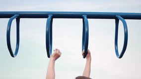 A looping video of a kids hands going monkey bars