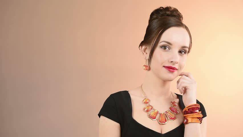 necklace on the neck. finger in mouth