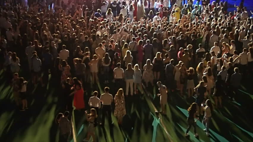 Teenagers crowd around stage at concert