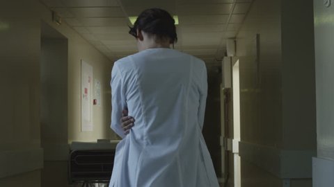 confused woman doctor in hospital hear something in corridor 