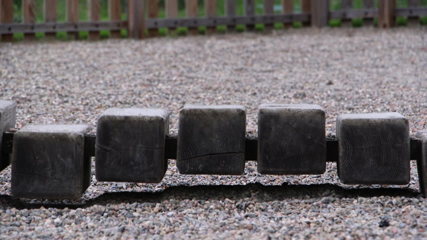 Child walking across wooden steps