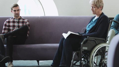 Doctor consulting patient in hospital waiting room
