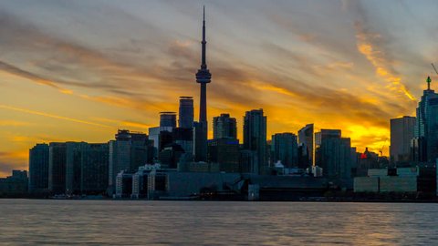 City of Toronto Sunset Time Lapse Day To Night 4K 1080p - Sun setting behind the city of Toronto Canada day to night skyline shot