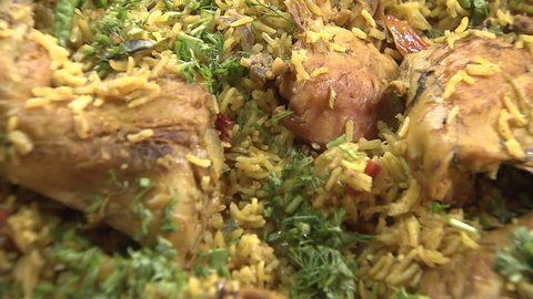 Arabic Food. CU zoom-out shot on a steaming dish of Mandi made with mutton, a traditional dish from Yemen but popular throughout the Gulf.