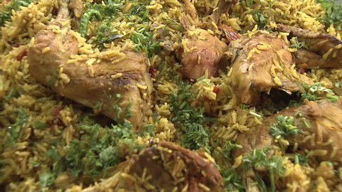 Arabic Food. ECU shot on the corriander decorating a steaming dish of Mandi, a traditional Yemeni dish but popular throughout the Gulf.