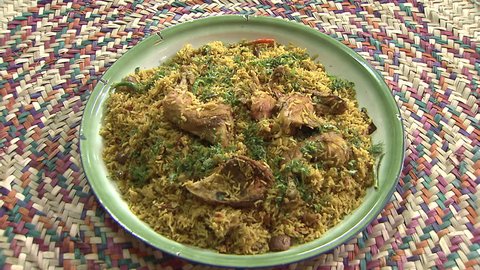 Arabic Food. CU top shot of a steaming dish of Mandi made with mutton and chicken, a traditional dish from Yemen but popular throughout the Gulf.
