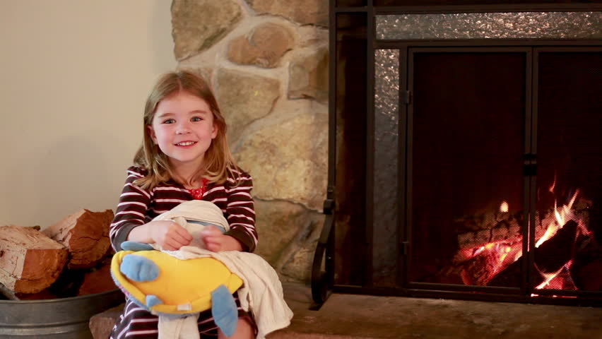 Cinemagraph of girl enjoying the day next to a fireplace.