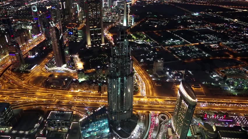 Dubai downtown at night, United Arab Emirates. Top view from the 124th floor of Burj Khalifa skyscraper in Dubai, currently the tallest structure in the world, 829,8 m. At the top - Burj Khalifa