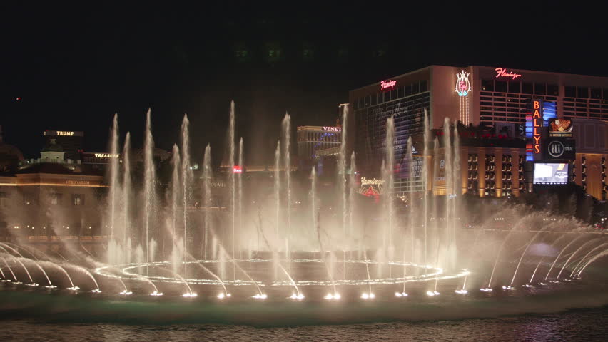 Las Vegas, Nevada 4-23-16: Bellagio Fountains at Night with Bright Lights of Hotels on The Strip | Shutterstock HD Video #16168240