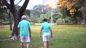 happy Asian senior couple walking exercise along the park. Abstract love health and nature