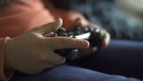 Two kids playing videogames. Close Up of hands with controller