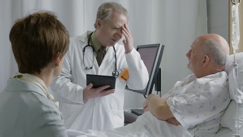 Physician showing regret while talking to his hospital patient | Shutterstock HD Video #16184335