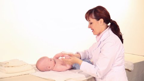 doctor massages baby