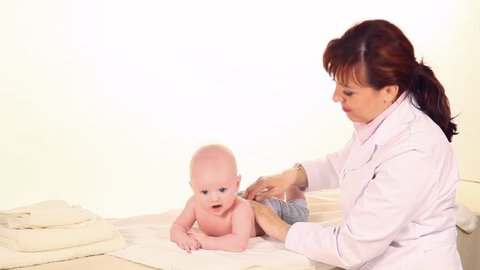 doctor massages baby