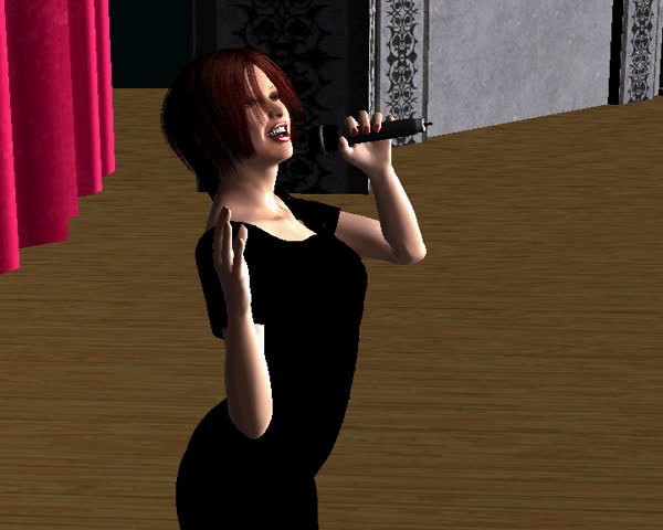 A woman on stage singing with a microphone in her hand.