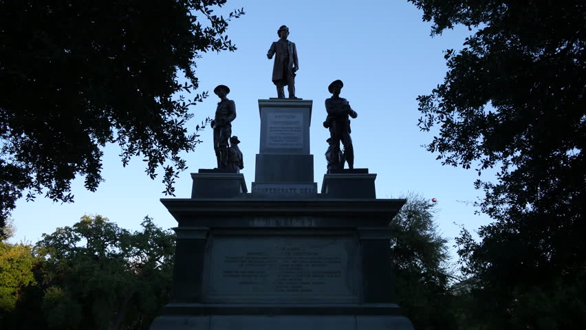 Figures of important Confederates stand against a blue sky on a monument on the Texas State Capitol grounds in Austin.