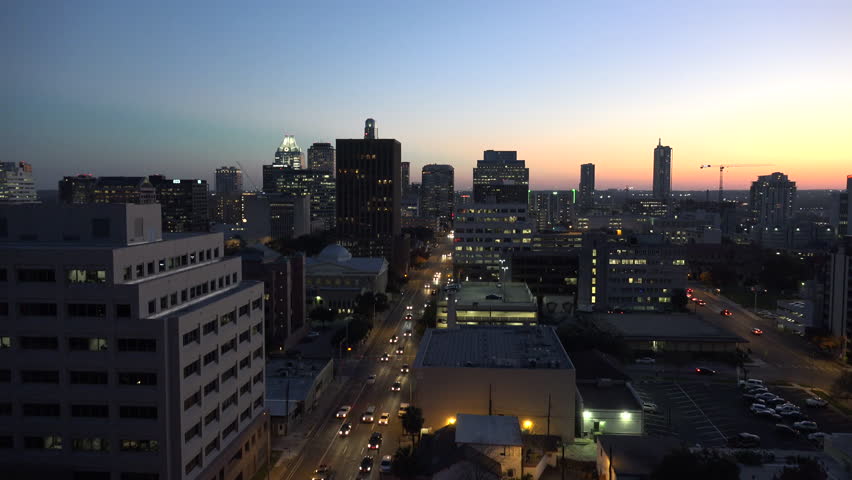 Zooms in on rush hour traffic on a downtown Austin street.