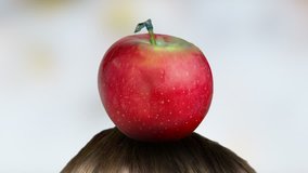 Targeting. Red apple on head hit by arrow. Colorful background. Close-up. Zoom out. Clip ID: arrow5_HD