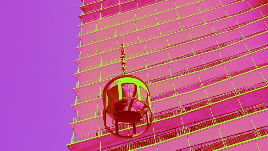 Candy cement bucket. Cement bucket gets lifted by crane. Coloured with candy colours in post. Condominium construction in Toronto, Ontario, Canada. 