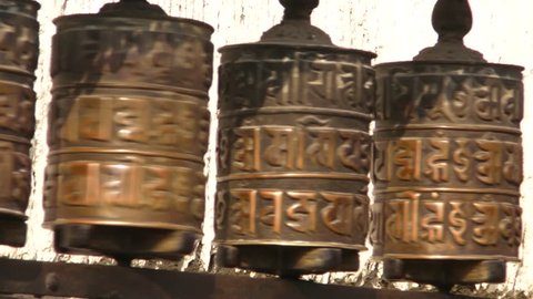 Praying drums. Line of vintage copper praying drums with sanskrit symbols in Swayambhunath, Nepal.