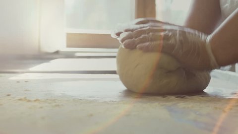 Baker kneading dough. Slow motion