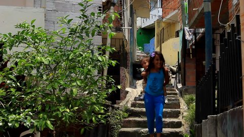 MEDELLIN, COLOMBIA - CIRCA APRIL 2014: CHILDREN WALK DOWN STAIRWAY IN THE  POOR NEIGHBORHOOD OF "COMUNA 13"