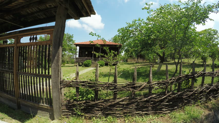 Wooden fence in front of wooden house