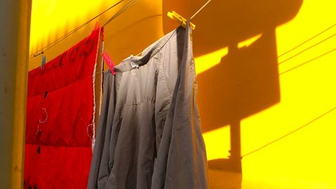 Hanging Clothes and Yellow Wall