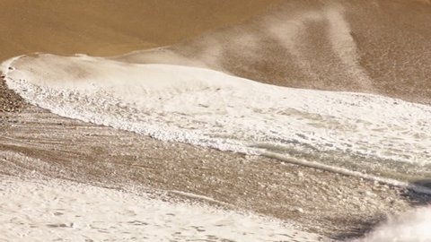 Waves crashing on a beautiful golden sand beach in California
