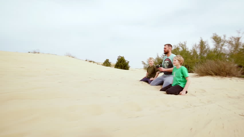 Family playing with remote controlling car. Slow motion