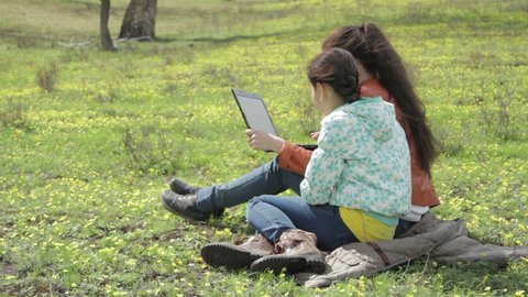 Girls in nature with laptop