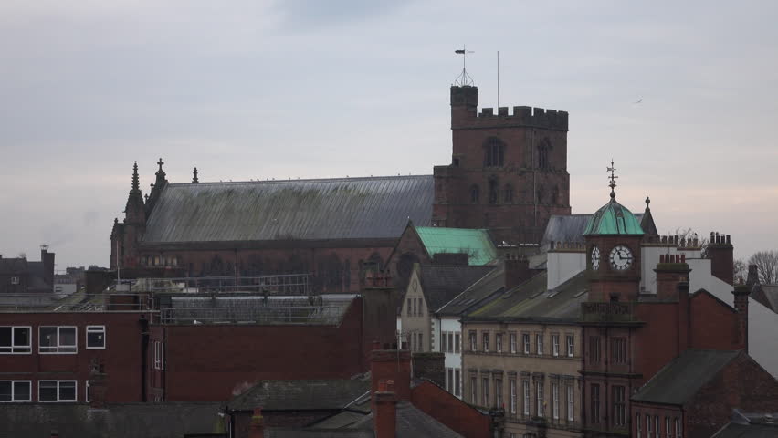 CARLISLE, ENGLAND -  CIRCA MAR 2016: Carlisle England Cathedral neighborhood apartments buildings. Augustinian priory became a cathedral in 1133. Parish members and tourist explore ancient building.